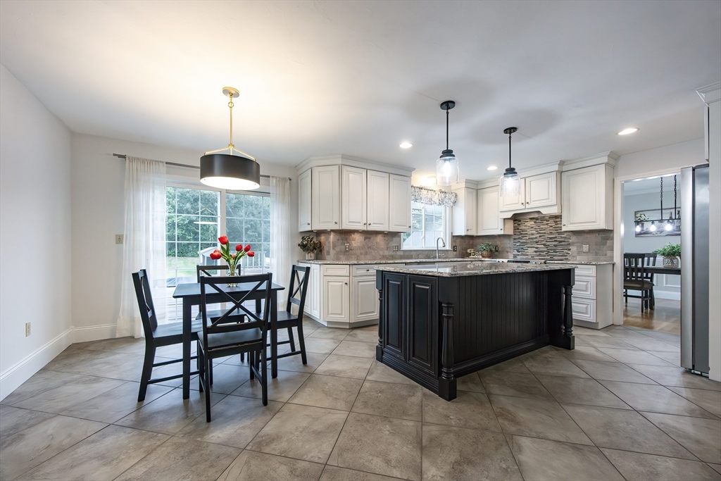 85 Sheldonville Road North Attleboro, MA 02760 - Photo 9 of 42 a kitchen with kitchen island granite countertop a sink counter and chairs