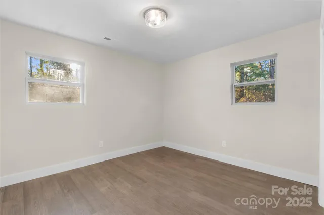 an empty room with a painting on the wall