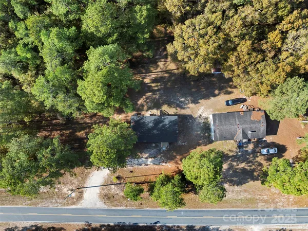 an aerial view of a houses with a yard