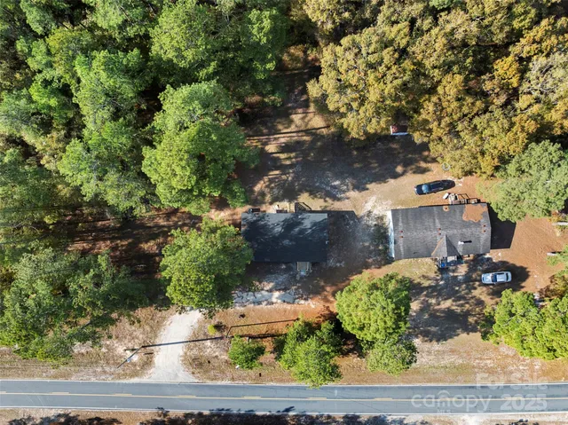 an aerial view of a houses with a yard
