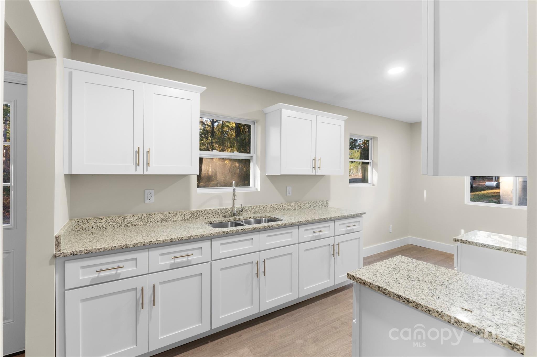 15861 Palmer Road Marston, NC 28363 - Photo 10 of 28 a kitchen with granite countertop kitchen island with white cabinets