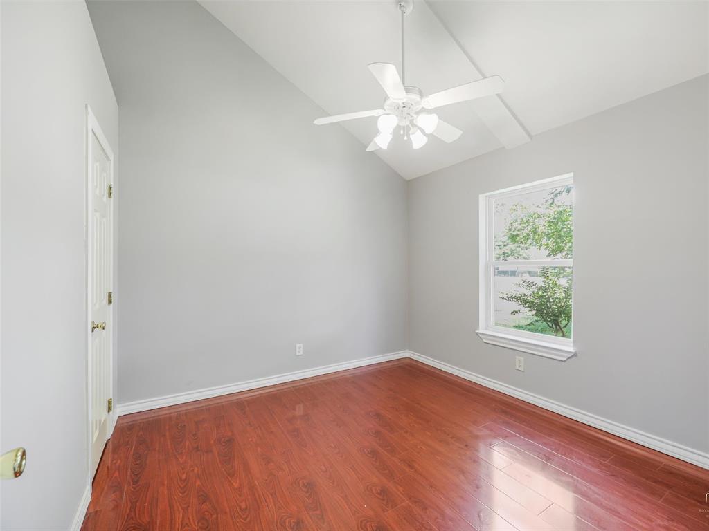 1716 East Parker Road Plano, TX 75074 - Photo 13 of 25 Room featuring a vaulted ceiling with exposed beams, wood-finish flooring, and a white ceiling fan with integrated lighting
