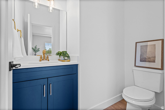 340 East 7635 S Street Sandy, UT 84047 - Photo 13 of 32 Half bathroom featuring vanity and dark wood-type flooring