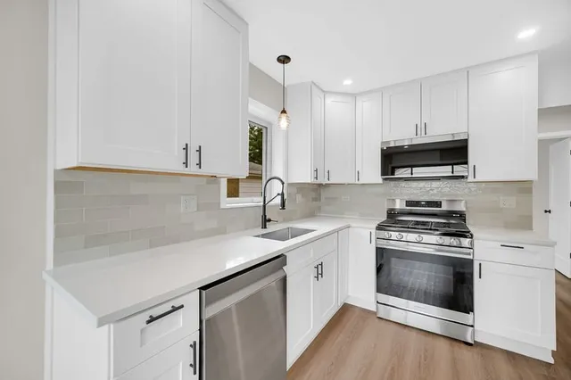 a kitchen with a sink cabinets and window