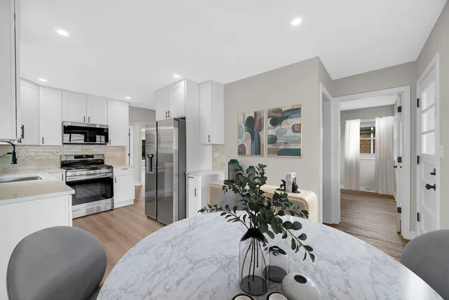 a kitchen with a refrigerator and a stove top oven