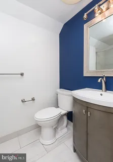 a bathroom with a sink a toilet and mirror