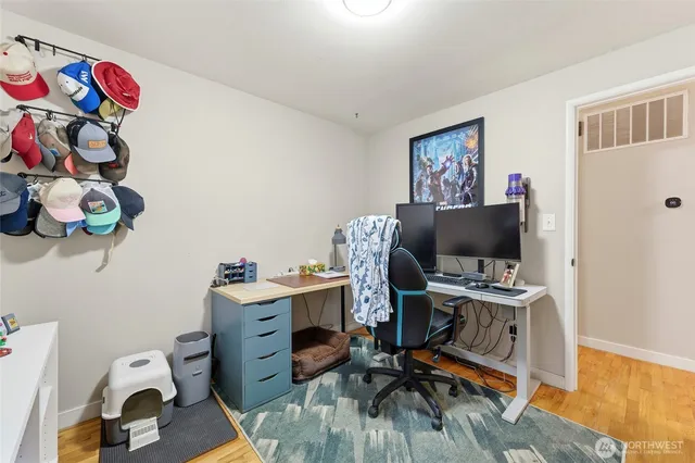a view of a workspace with furniture and a window