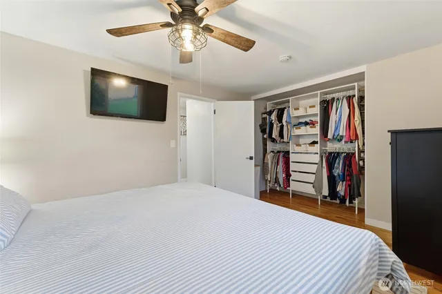 a bedroom with a bed and a flat screen tv