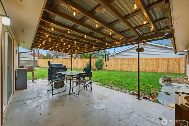 a view of a porch with furniture and a yard