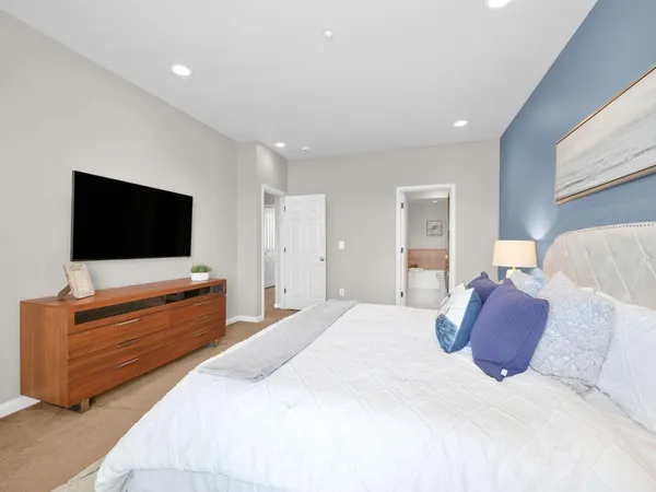 a bedroom with a bed and a flat screen tv