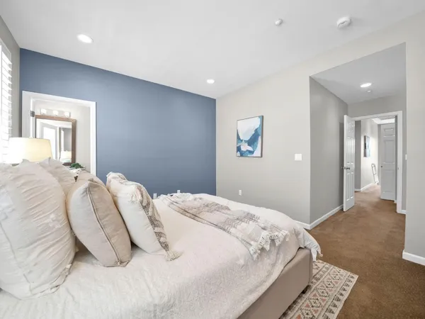 a bedroom with a bed and a painting