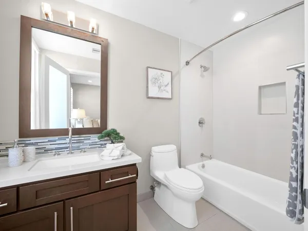 a bathroom with a sink a toilet and a mirror