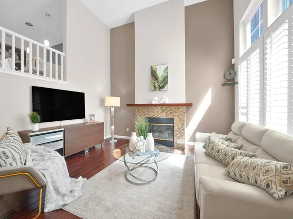 a living room with furniture a flat screen tv and a fireplace