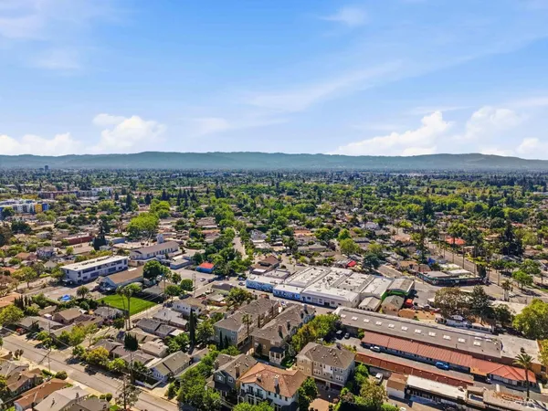 an aerial view of residential houses with city view