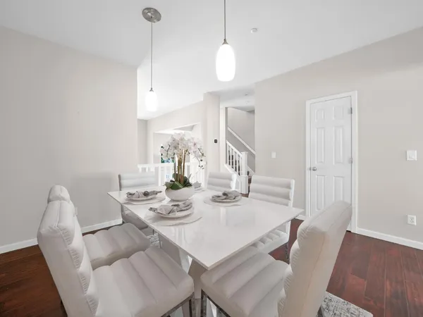 a view of a dining room with furniture wooden floor and chandelier