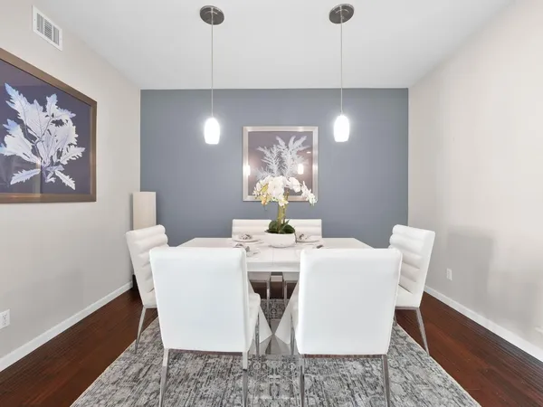 a view of a dining room with furniture and wooden floor