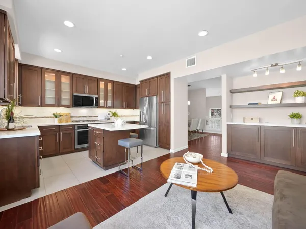 a kitchen with a refrigerator dining table and chairs