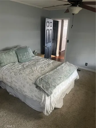 a bed sitting in a bedroom next to a window