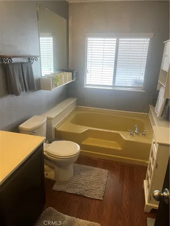 a bathroom with a toilet and a tub