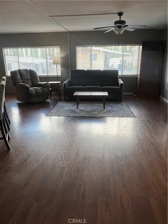 a living room with furniture window and wooden floor
