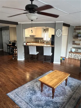 a living room with table tennis pool table and chairs