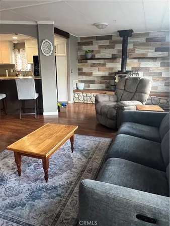 a living room with furniture a rug and white walls