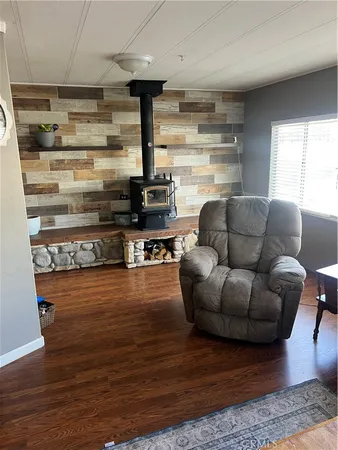 a living room with furniture wooden floor and a fireplace