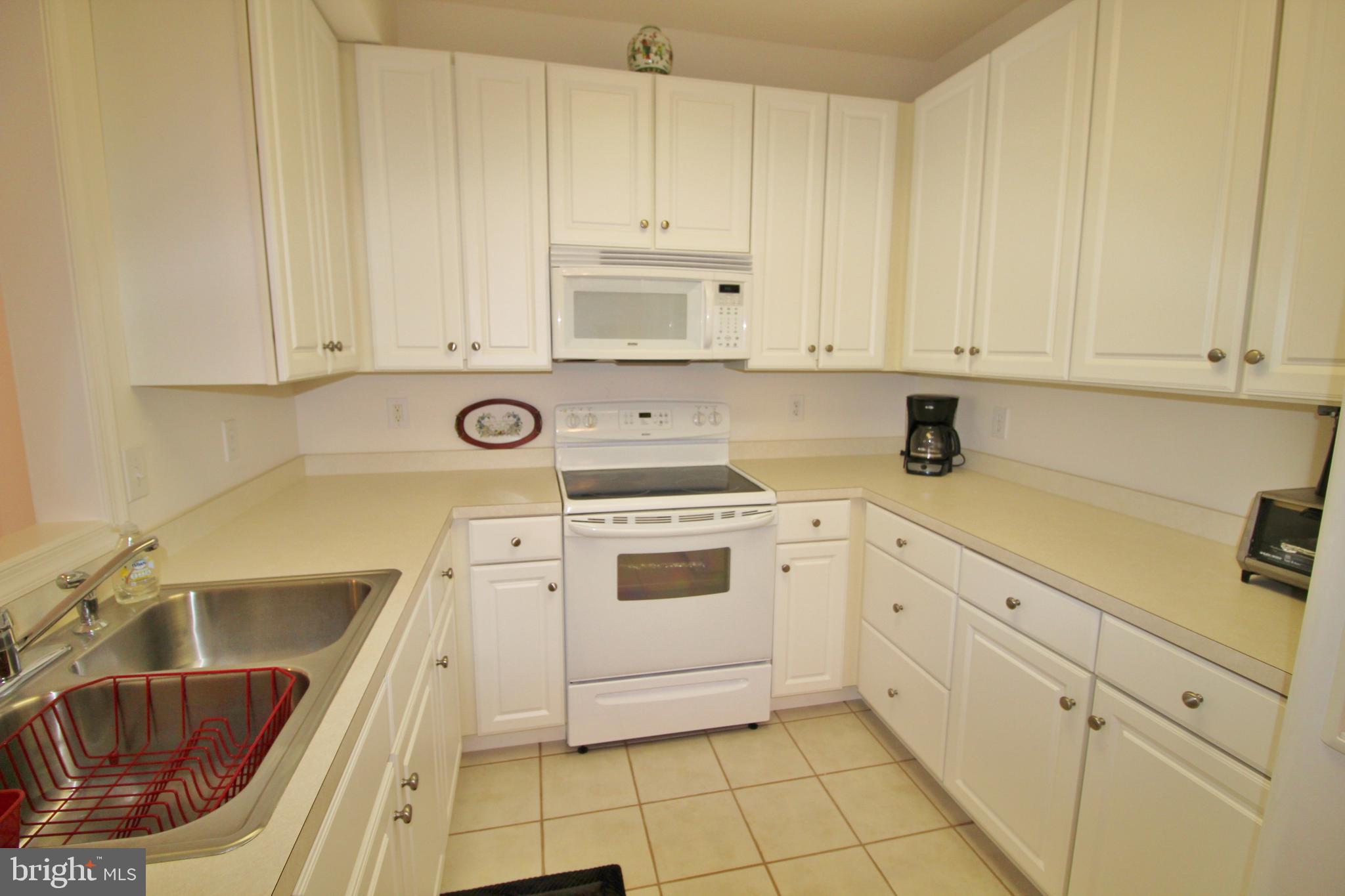 30619 Cedar Neck Road, Unit 1201 Ocean View, DE 19970 - Photo 10 of 30 Kitchen offers white neutral palette