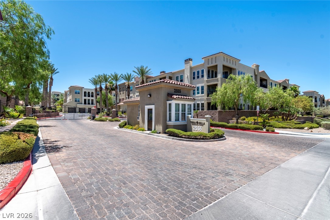 2555 Hampton Road, Unit 6308 Henderson, NV 89052 - Photo 25 of 30 Terra Bella Condominium gate entrance with an inviting paver driveway and meticulously maintained landscaping.