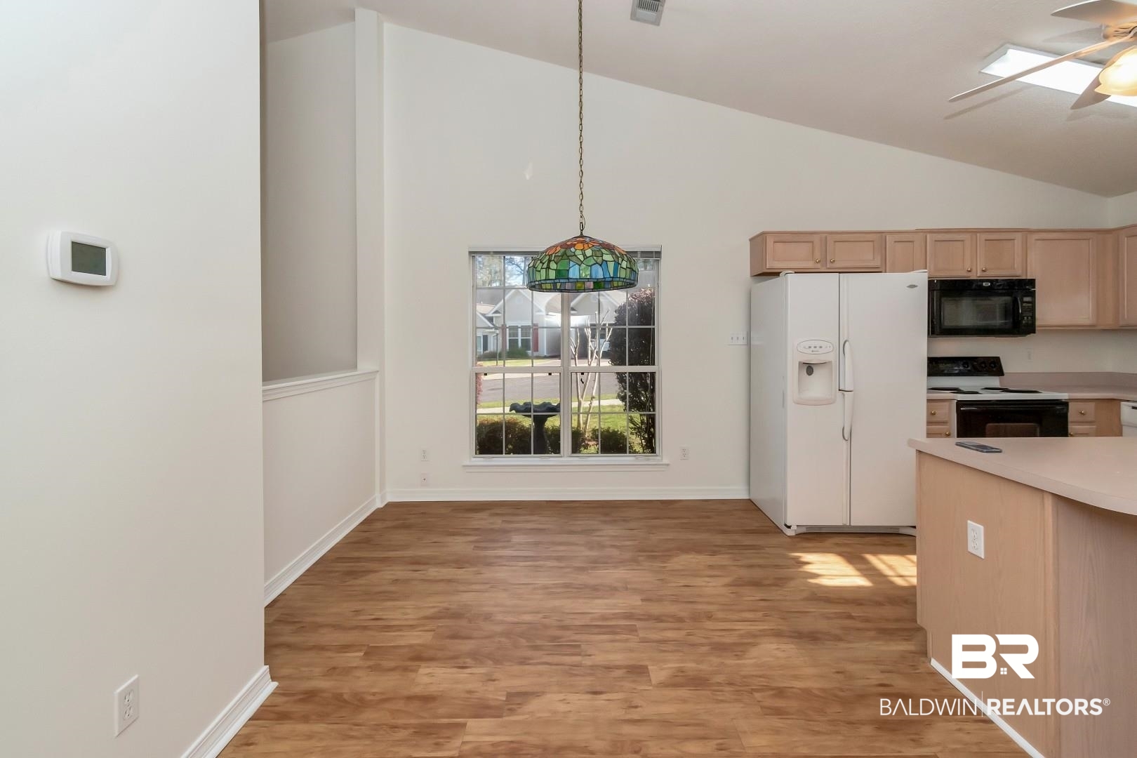 672 Spring Lake Drive East Mobile, AL 36695 - Photo 21 of 26 Kitchen featuring light brown cabinets, lofted ceiling, ceiling fan, black appliances, and light wood-style floors