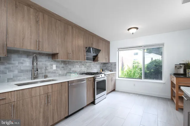 a kitchen with a sink window and cabinets