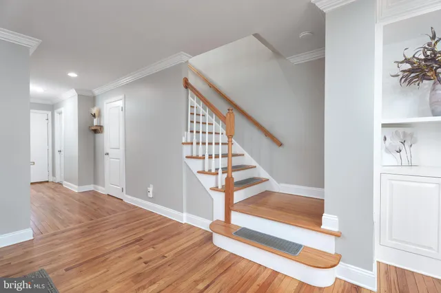 a view of entryway and hall with wooden floor