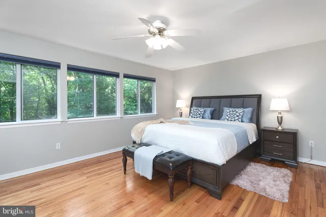 a bedroom with a large bed and a chandelier