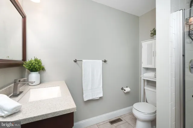 a bathroom with a sink toilet and a mirror