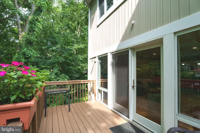 a balcony with wooden floor and outdoor space
