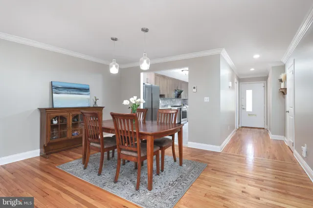 a dining room with furniture and wooden floor