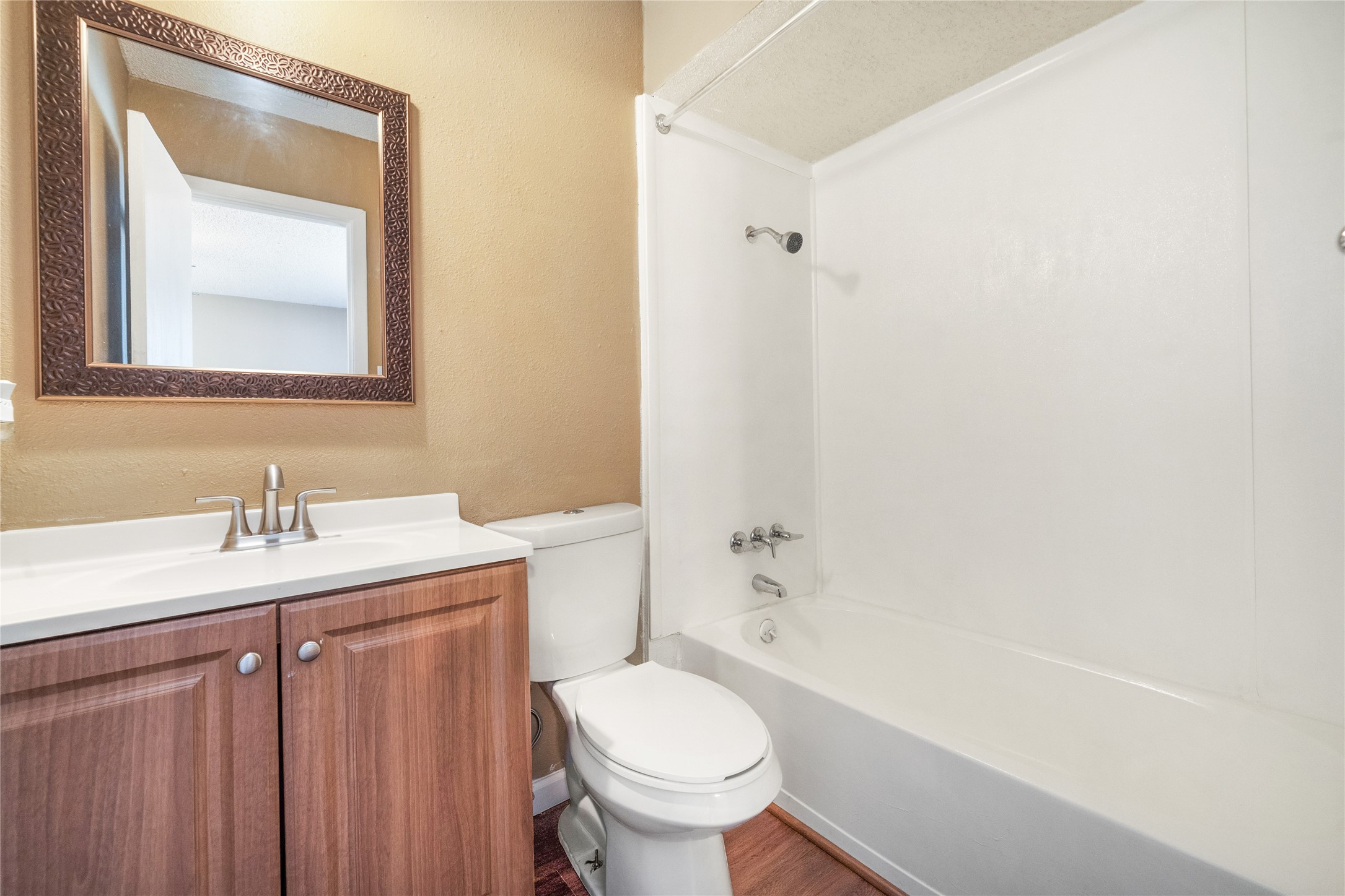 5412 Atascosa Drive, Unit B Austin, TX 78744 - Photo 13 of 15 Full bath with shower / bathtub combination, vanity, wood finished floors, and a textured wall