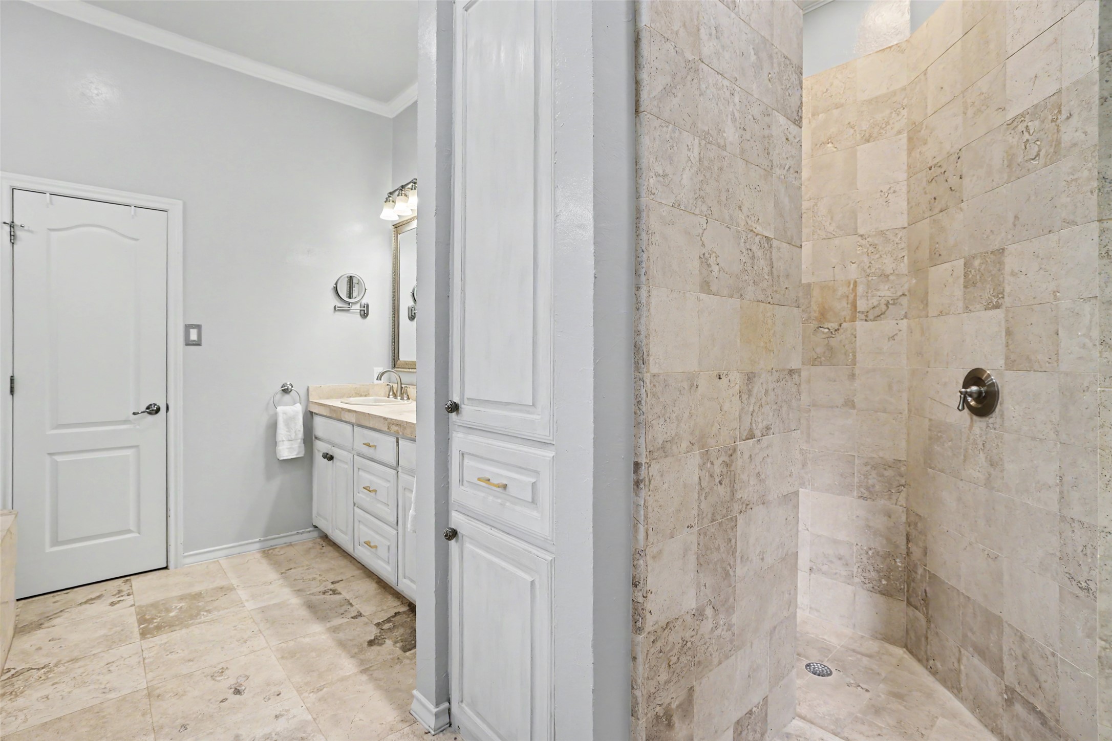 426 Logan Ranch Road Georgetown, TX 78628 - Photo 18 of 40 The primary on suite bathroom has a walk in shower with travertine floors