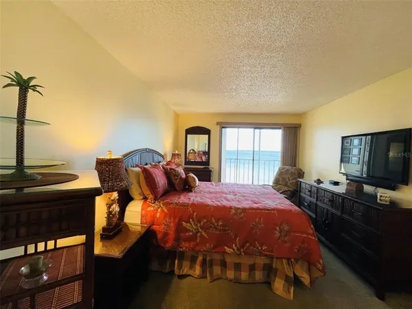 a bedroom with two beds and a flat screen tv