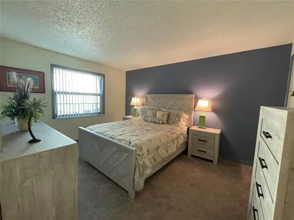 a bedroom with a bed and a desk