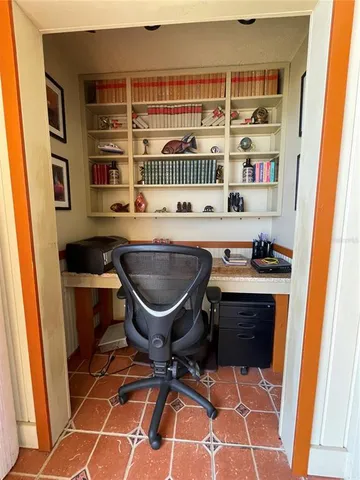 a table chair sitting in a kitchen next to a cabinet