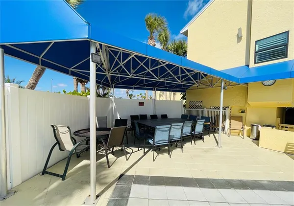 a patio with table and chairs