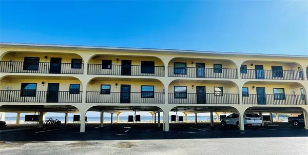 a front view of a residential apartment building with a yard