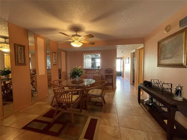 a view of a dining room with furniture and chandelier