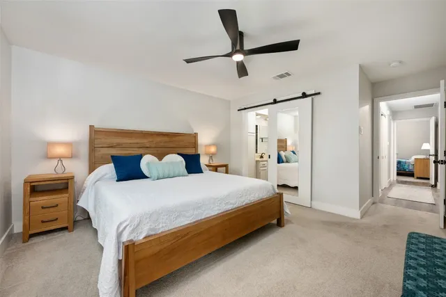 a bedroom with a bed and a lamp