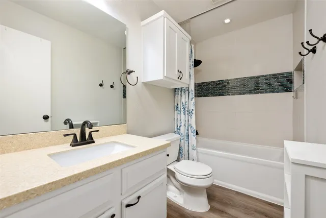 a bathroom with a sink a toilet and a bathtub