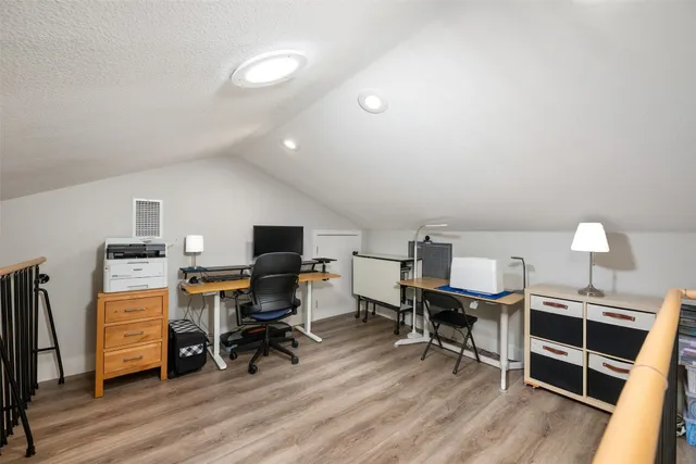 a workspace with furniture and wooden floor