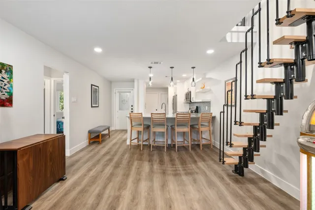 a dining hall with stainless steel appliances lots of wooden furniture