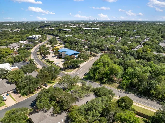 an aerial view of residential houses with outdoor space and river