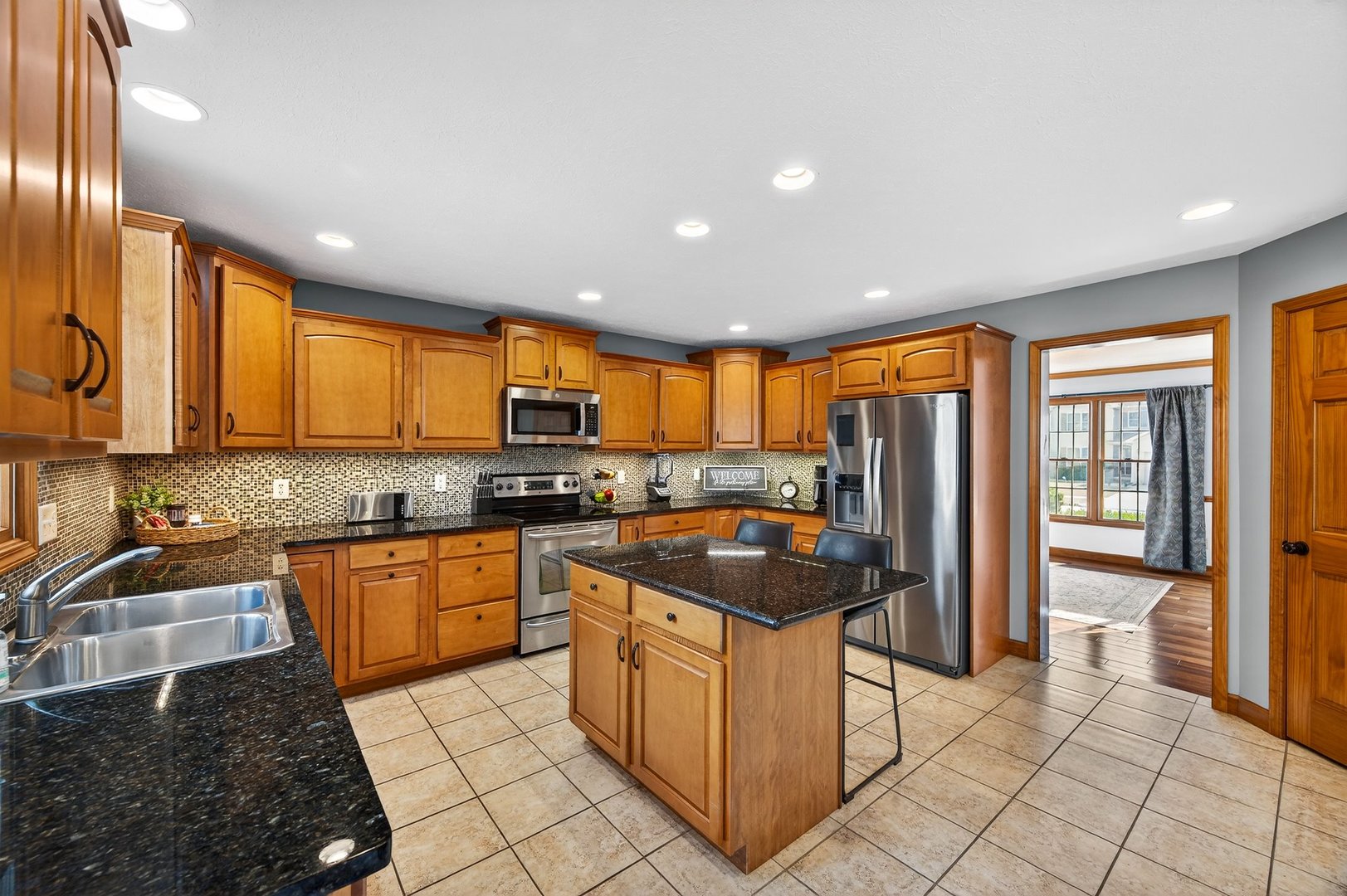 2968 Wolf Creek Lane Normal, IL 61761 - Photo 12 of 47 a kitchen with stainless steel appliances granite countertop a stove a sink and a refrigerator